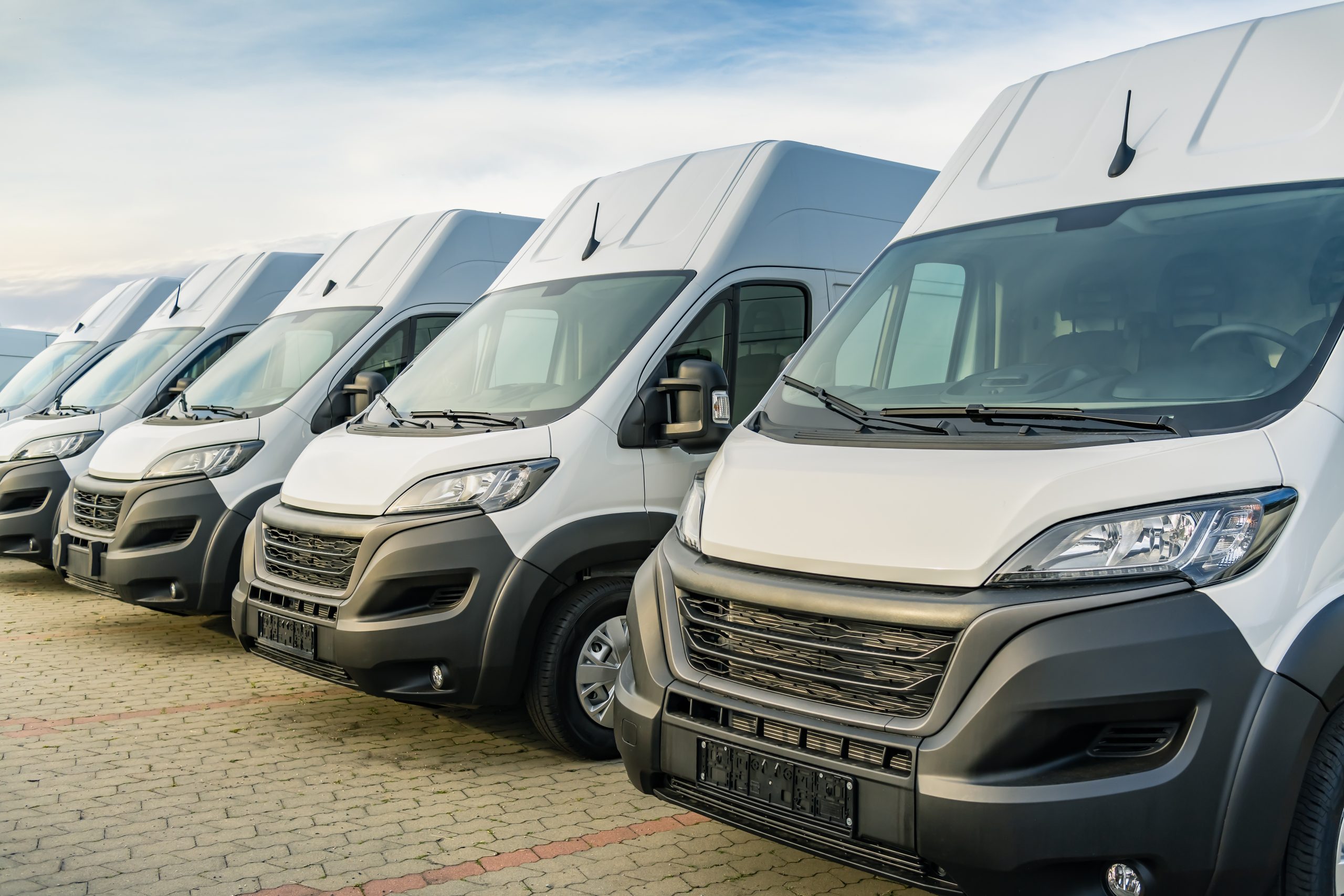 commercial,delivery,vans,parking,in,a,row,,transporting,and,shipping